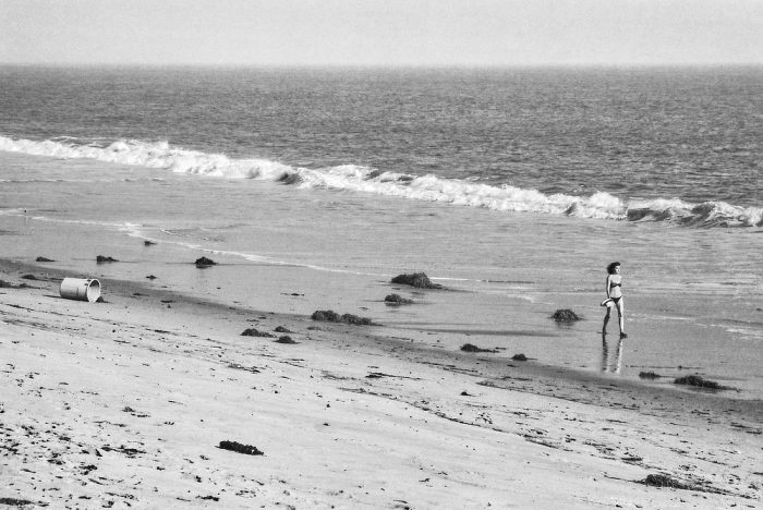 Jeune femme en maillot de bain marchant sur la plage de Malibu, Alone in LA